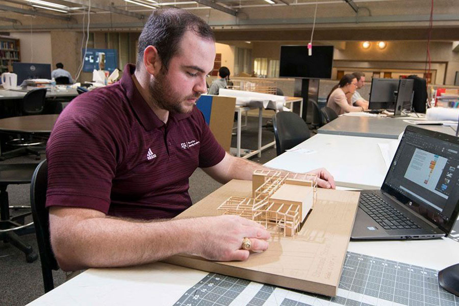 An architecture student working on a model building